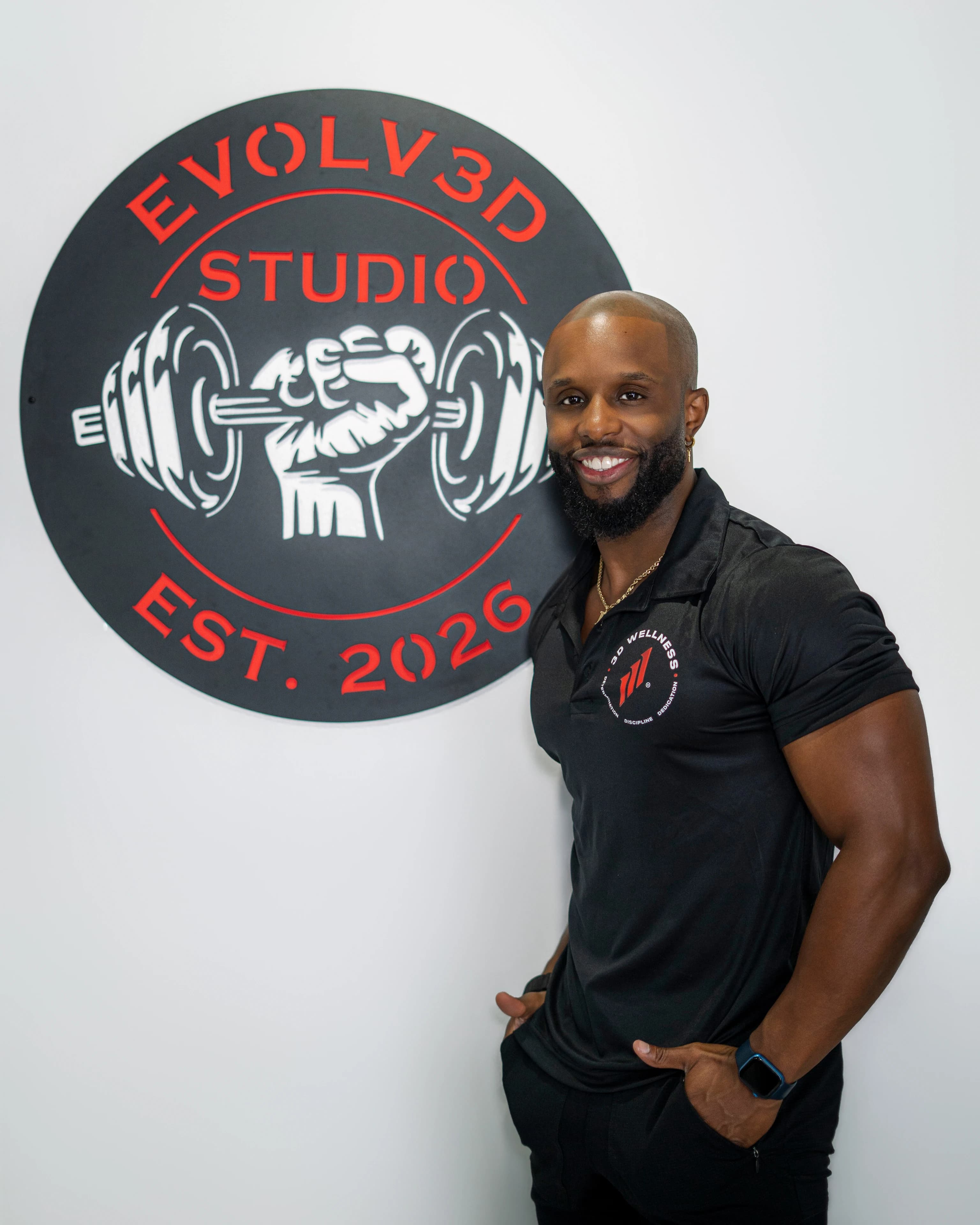 Daniel Triche beside the Evolv3D Studio sign