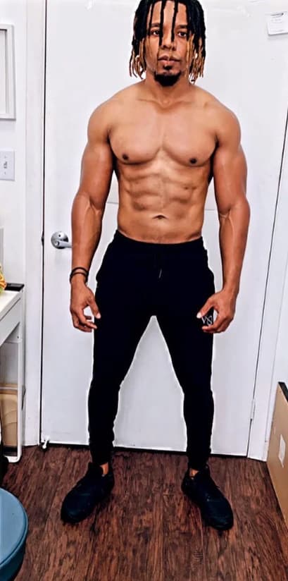After: the same client, lean and muscular, standing in a doorway
