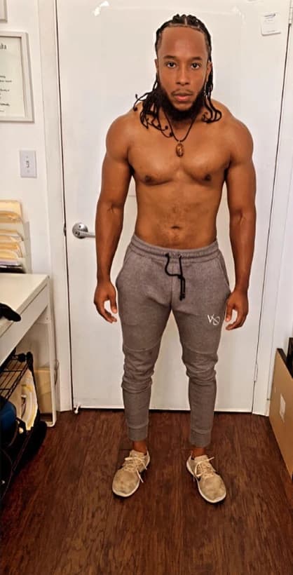 After: the same client, leaner and more defined, standing in a doorway