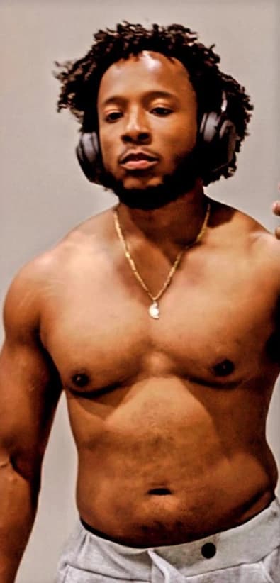 Before: a shirtless client wearing headphones