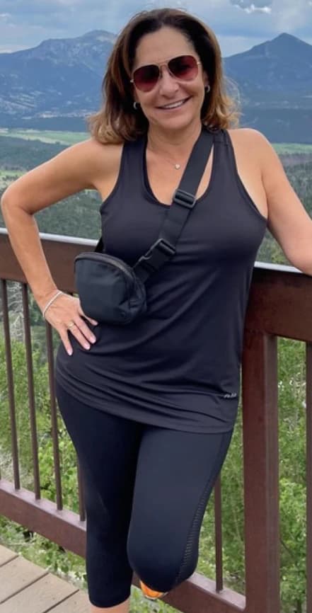 Before: a client in a tank top on a mountain overlook